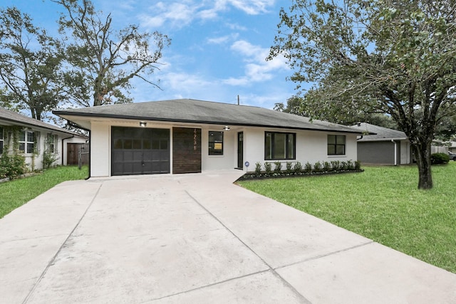 ranch-style home with a garage and a front lawn