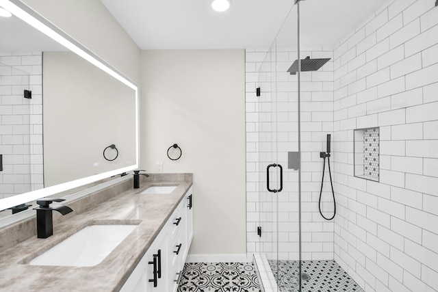 bathroom featuring tile patterned flooring, vanity, and an enclosed shower