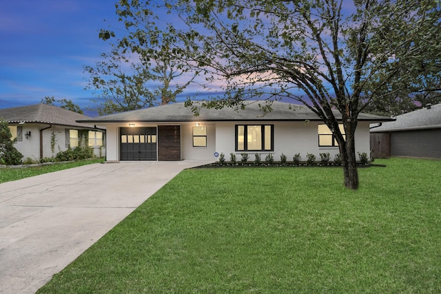 single story home with a yard and a garage