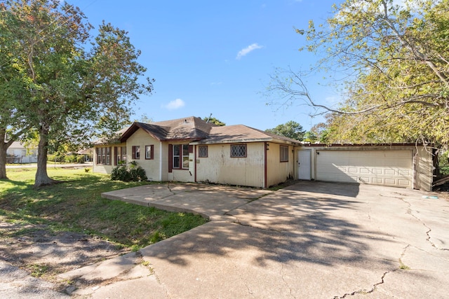 ranch-style house with a garage and a front lawn