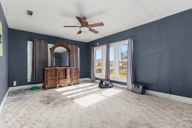 unfurnished living room with carpet and ceiling fan