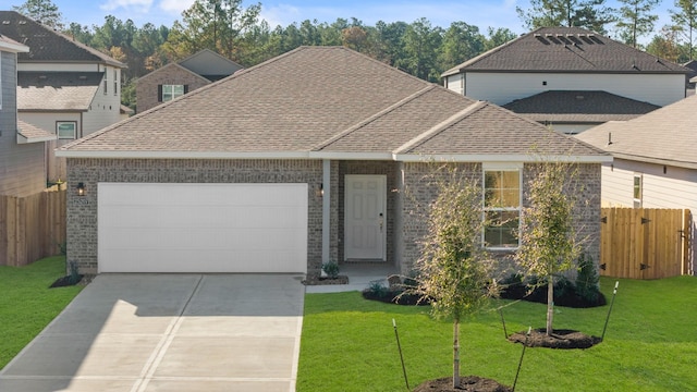 view of property featuring a garage and a front yard