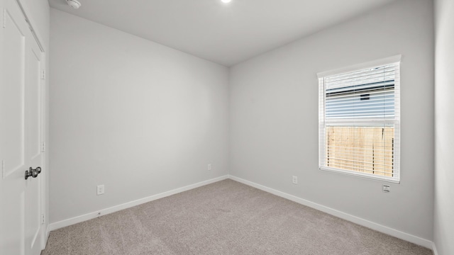 carpeted spare room with plenty of natural light