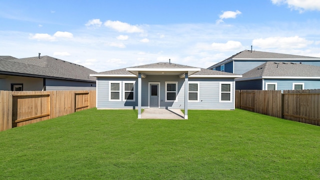 rear view of property featuring a patio and a yard