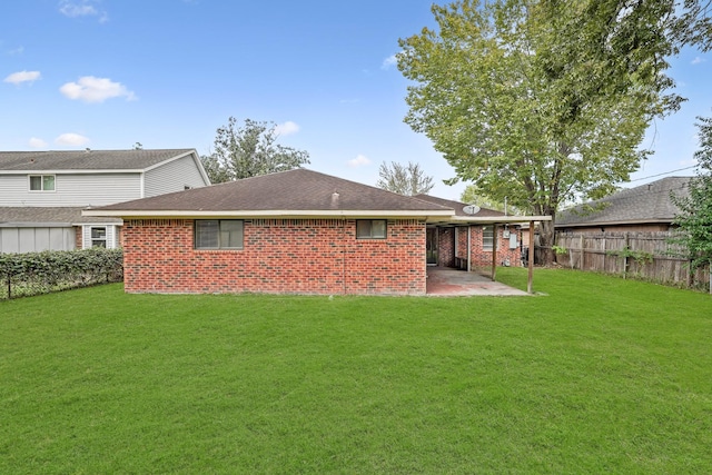 back of house with a lawn and a patio