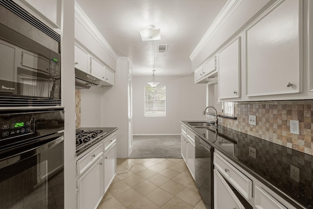 kitchen featuring white cabinets, decorative backsplash, black appliances, and sink