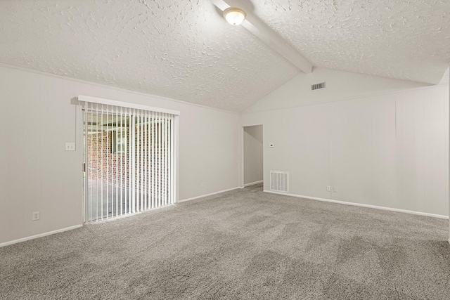 carpeted empty room with lofted ceiling with beams and a textured ceiling