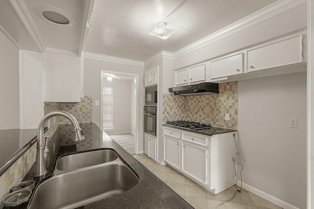 kitchen with white cabinets, sink, decorative backsplash, light tile patterned floors, and appliances with stainless steel finishes