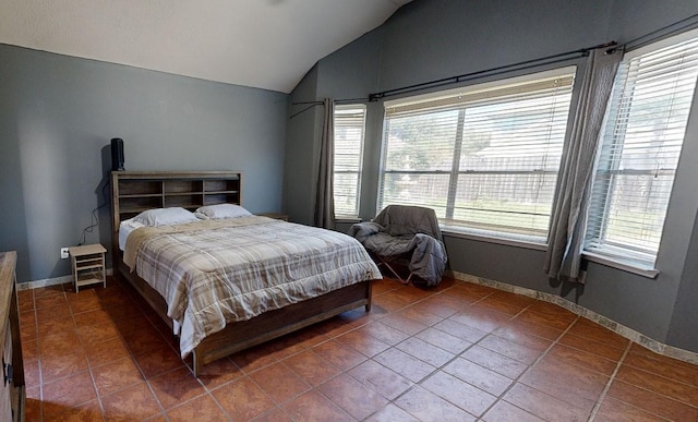 tiled bedroom with lofted ceiling