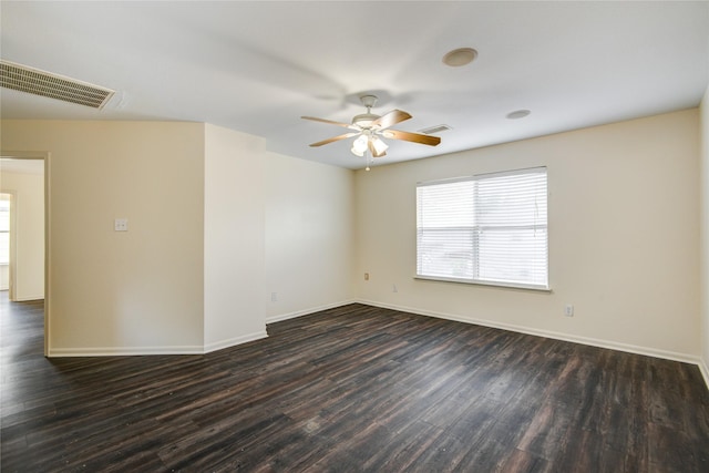 empty room featuring dark hardwood / wood-style flooring and ceiling fan