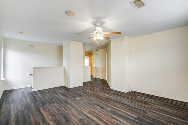 empty room with ceiling fan and dark hardwood / wood-style flooring