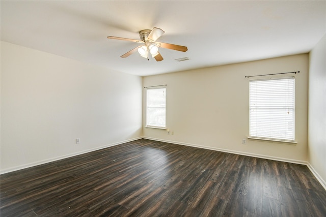 spare room with ceiling fan and dark hardwood / wood-style flooring