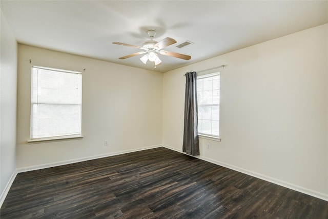 unfurnished room with ceiling fan, dark hardwood / wood-style flooring, and a wealth of natural light