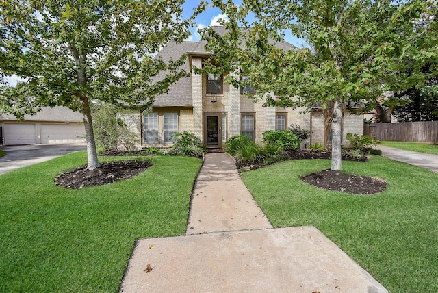 view of front of property featuring a garage and a front lawn