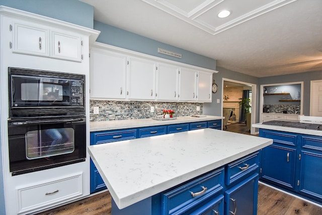 kitchen featuring a center island, dark hardwood / wood-style floors, blue cabinets, white cabinets, and black appliances