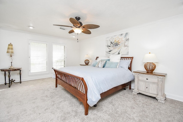 carpeted bedroom featuring ceiling fan and ornamental molding