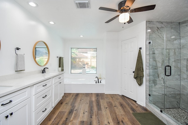 bathroom with vanity, separate shower and tub, wood-type flooring, and ceiling fan