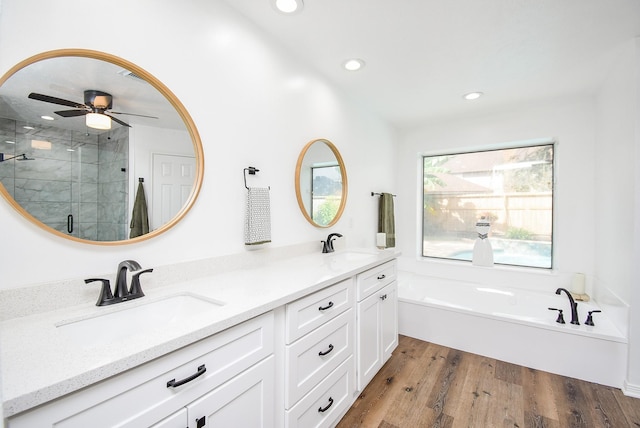 bathroom featuring ceiling fan, hardwood / wood-style floors, vanity, and independent shower and bath