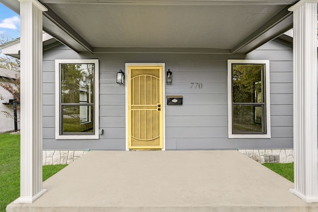 view of exterior entry with covered porch