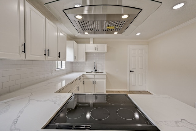 kitchen featuring crown molding, sink, white cabinets, and black range