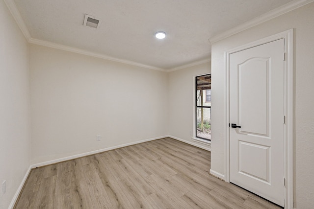 unfurnished room featuring crown molding and light hardwood / wood-style flooring