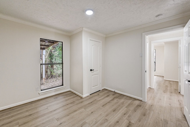 interior space with a textured ceiling, a closet, crown molding, and light hardwood / wood-style flooring