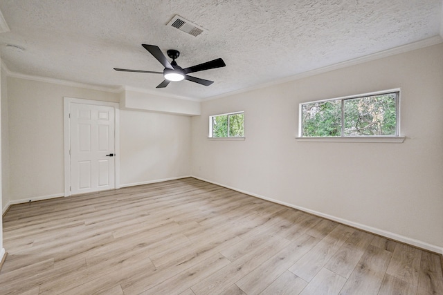 spare room featuring crown molding, light hardwood / wood-style flooring, ceiling fan, and a textured ceiling