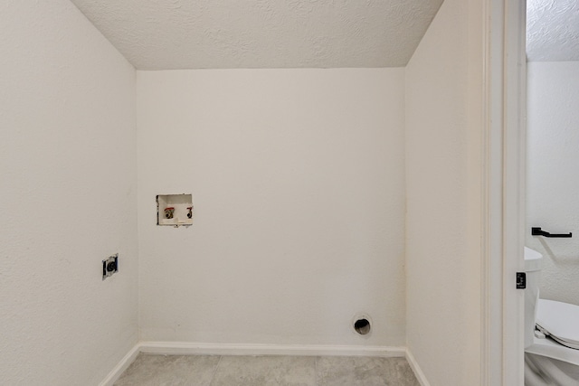 laundry area featuring electric dryer hookup, washer hookup, and a textured ceiling