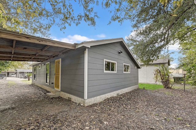 view of home's exterior featuring a carport