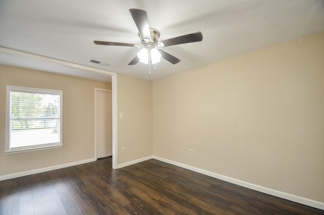 empty room featuring a textured ceiling, ceiling fan, and dark hardwood / wood-style floors