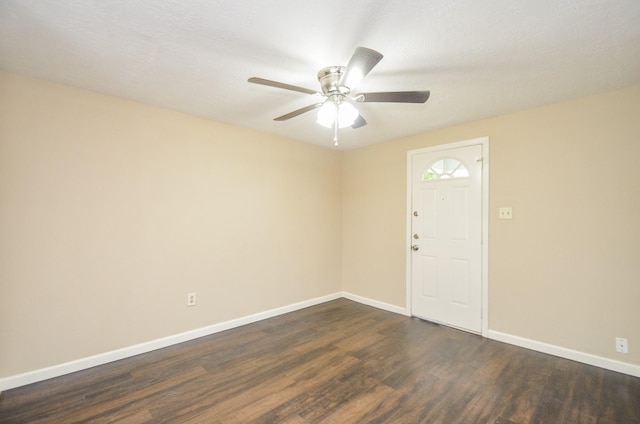 foyer featuring a textured ceiling, ceiling fan, and dark hardwood / wood-style floors