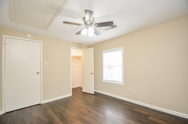 unfurnished bedroom featuring a textured ceiling, ceiling fan, and dark wood-type flooring