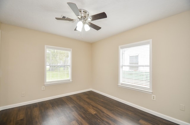 spare room with ceiling fan and dark wood-type flooring