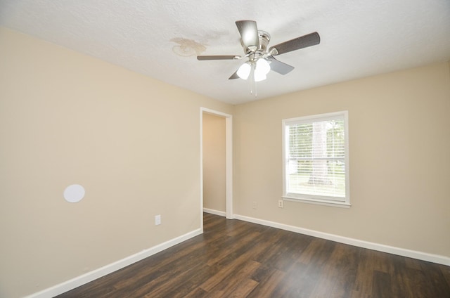 spare room featuring a textured ceiling, ceiling fan, and dark wood-type flooring