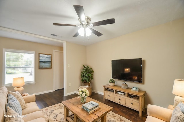 living room with ceiling fan and dark wood-type flooring