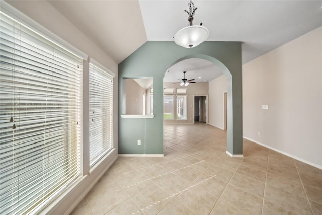 tiled spare room with ceiling fan and vaulted ceiling