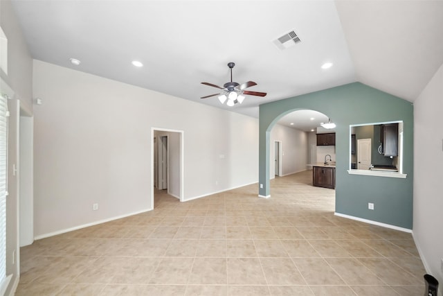 unfurnished living room with light tile patterned floors, ceiling fan, lofted ceiling, and sink