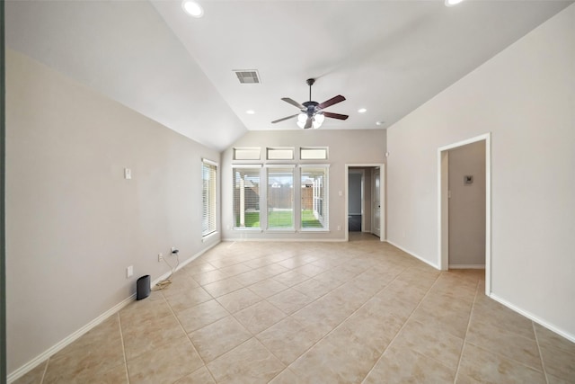 tiled empty room with ceiling fan and vaulted ceiling