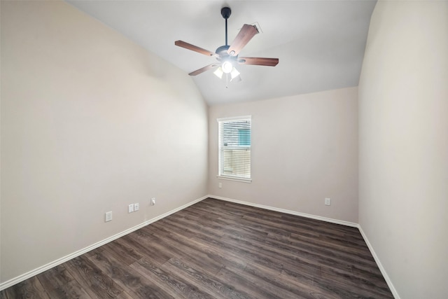 empty room featuring vaulted ceiling, ceiling fan, and dark wood-type flooring