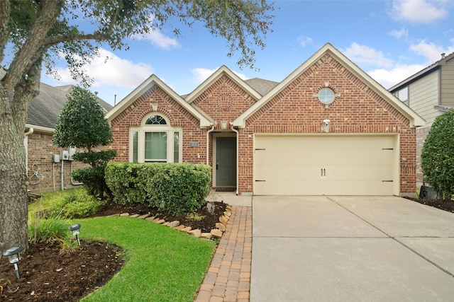 view of front of property with a garage and a front lawn