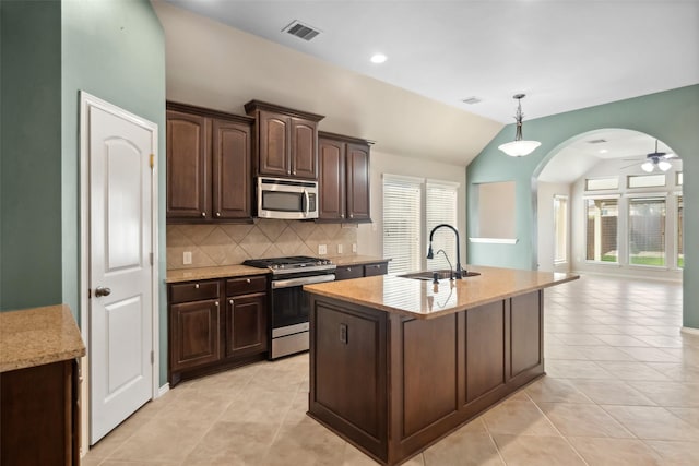 kitchen featuring sink, lofted ceiling, stainless steel appliances, and a wealth of natural light