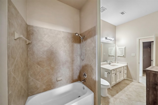 full bathroom with tile patterned floors, vanity, tiled shower / bath combo, and toilet