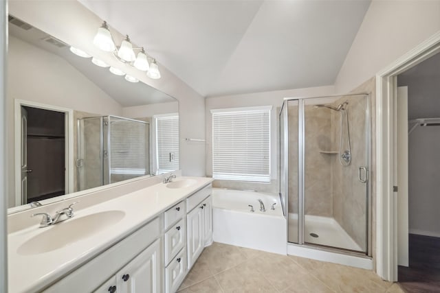 bathroom featuring tile patterned floors, separate shower and tub, vanity, and lofted ceiling