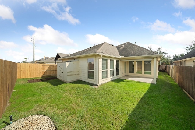 rear view of property featuring a lawn