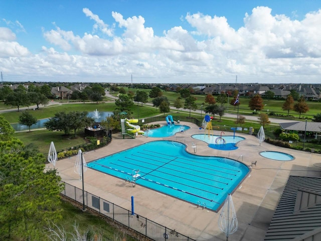 view of pool with a water view and a patio