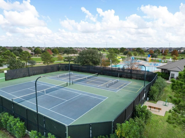 view of tennis court with basketball court and a fenced in pool