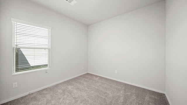 unfurnished room featuring light carpet