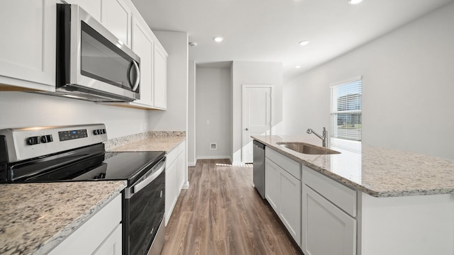 kitchen featuring sink, an island with sink, white cabinets, and appliances with stainless steel finishes