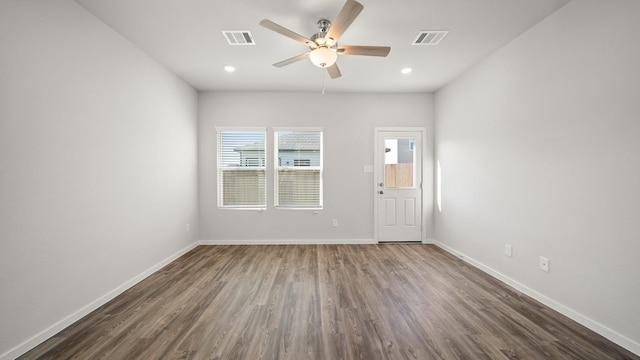 unfurnished room featuring ceiling fan and dark hardwood / wood-style flooring