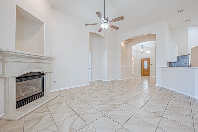 unfurnished living room with ceiling fan